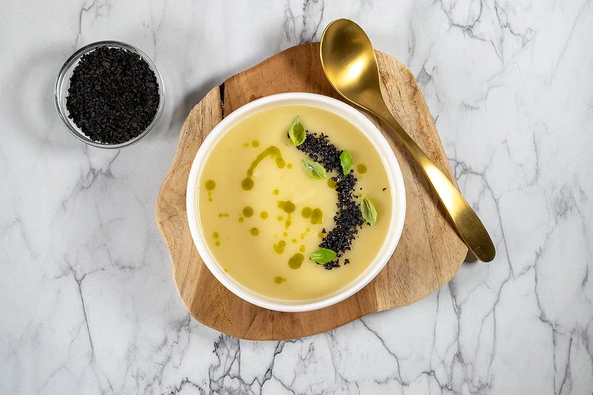 Pastinaaksoep met basilicum en olijven crumble