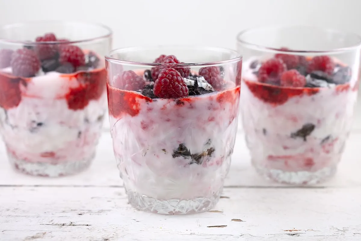 Aardbeien en frambozentoetje in een glas